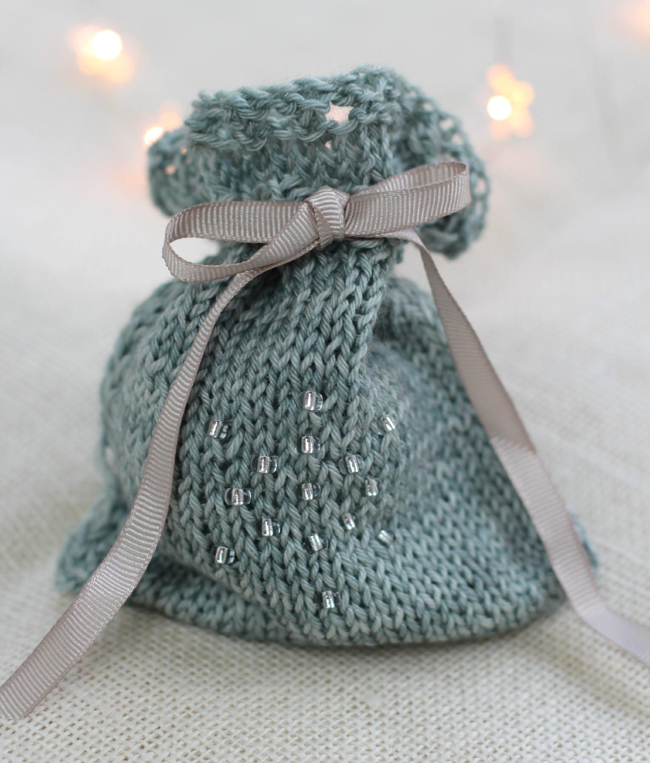 Knit Adorn Gift Bag Knit Pattern for a small green knit bag with silver diamontees and a silver ribbon.