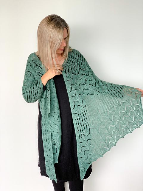 Knitting Designer Helen Stewart models a green lace shawl named the In The Dunes Wrap