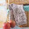 The Picnic Blanket Socks deigned by Helen Stewart/Curious Handmade, with a picnic basket and red apples
