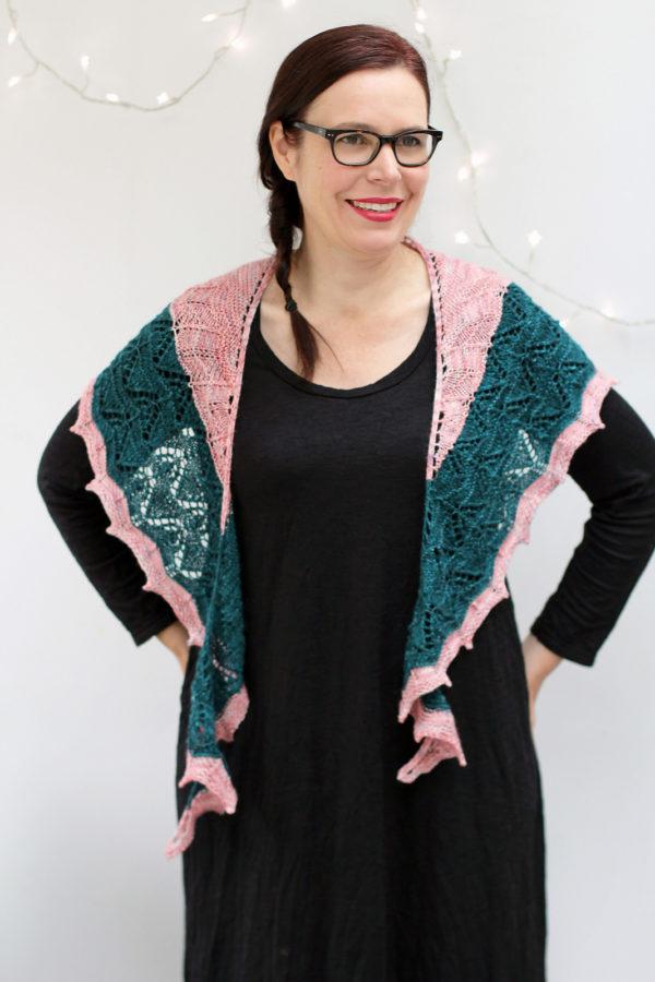 Delicate fine knit pink shawl with green stripe.