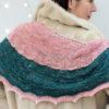 Delicate fine knit pink shawl with green stripe.
