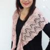 Delicate fine knit pink shawl with green stripe.