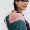 Delicate fine knit pink shawl with green stripe.