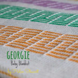 The Georgie Baby Blanket is a white with yellow, purple, green and orange pattern