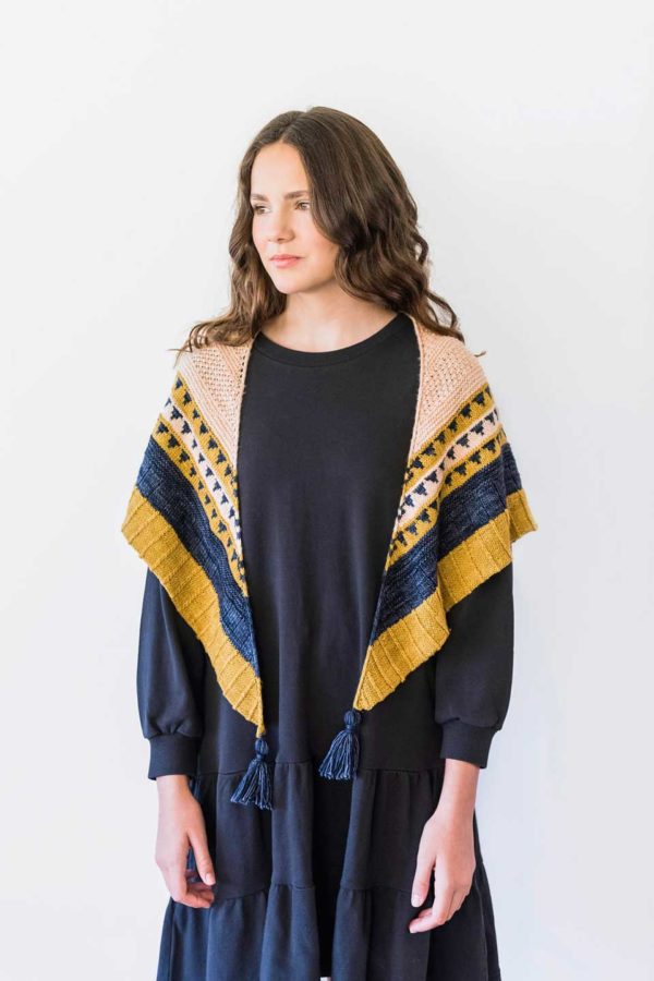 The Hinterlands Shawl is a generous triangle shawl, knit in three colours - blue, yellow and cream.