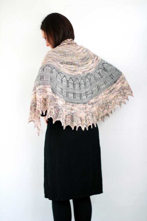 The Maytham Shawl is a generous shawl using two colours, in a semicircular shape. The texture and easy lace with soaring arches and columns.