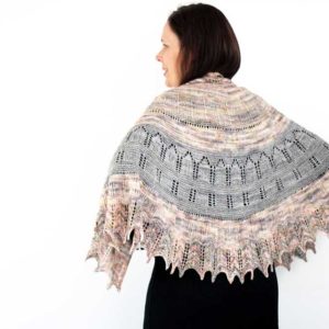 The Maytham Shawl is a generous shawl using two colours, in a semicircular shape. The texture and easy lace with soaring arches and columns.