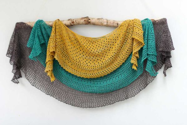 Pebble Beach Shawl is a light crescent shaped accessory, perfect for keeping off chilly sea breezes while at the beach.