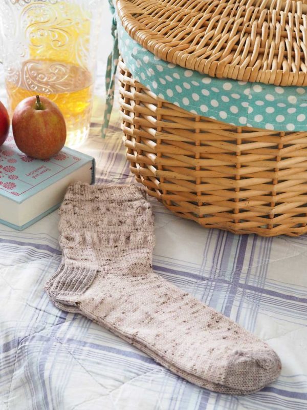 The Picnic Blanket Socks have a ruched stitch pattern, and the top down with a simple 2x2 rib cuff, and a gusset with a rounded toe.