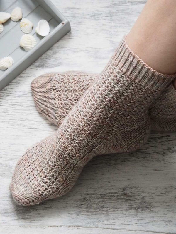The Shell Cottage Socks look impressive, but the pattern is simple and gratifying. The stretchy rib makes them cosy and squishy.