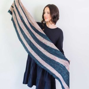 The Silver River Shawl is a short row crescent shawl, knit in two colours, with an interesting construction and a lighthearted attitude.