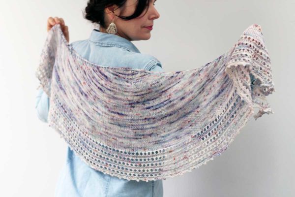 The Spindrift Shawl is inspired by the expansive Pacific Ocean. The deep sea swell of the crescent shape is complemented by a deep eyelet border and picot edge which froths like the foam at the crest of a wave.
