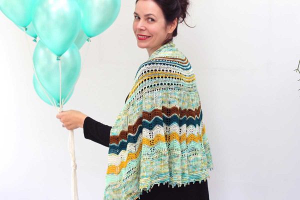 With simple lace, a graphic twisted rib stitch section and a relaxing garter stitch, Surprise Party Shawl is a captivating and addictive knit.