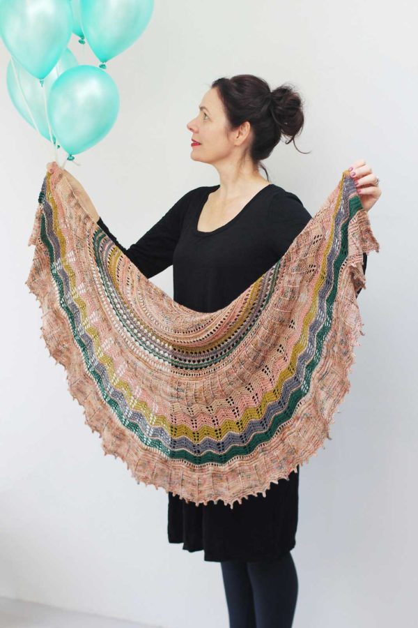 With simple lace, a graphic twisted rib stitch section and a relaxing garter stitch, Surprise Party Shawl is a captivating and addictive knit.