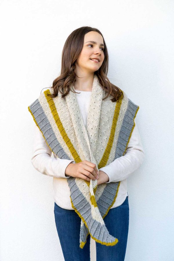 The three-colour triangle Tidings Shawl features big stripes of texture, with sections of ribbing and a beautiful, easy-to-memorise stitch pattern.