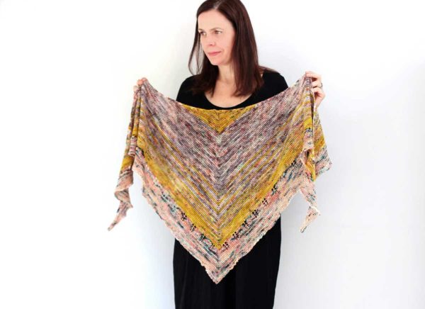 The Wick Shawl design is modern and fun. Combining favourite single skeins from stash, and the easy garter stitch base makes this a fast and satisfying knit.