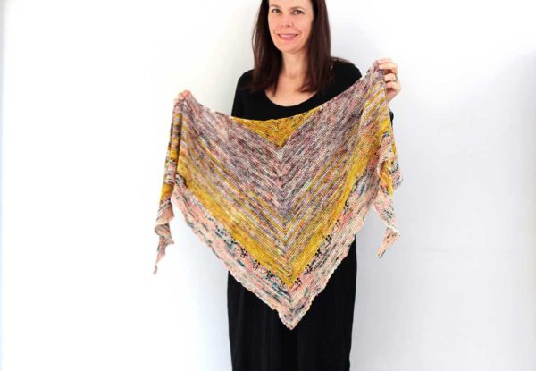 The Wick Shawl design is modern and fun. Combining favourite single skeins from stash, and the easy garter stitch base makes this a fast and satisfying knit.