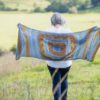 The Wild Bees Wrap is a three-colour rectangular wrap is a fun and engaging knit on a grand scale, with plenty of interest.